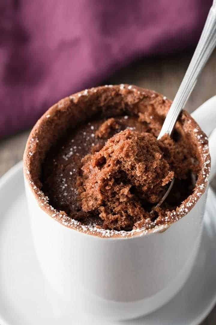 close up of a spoon taking a bite out of Nutella mug cake