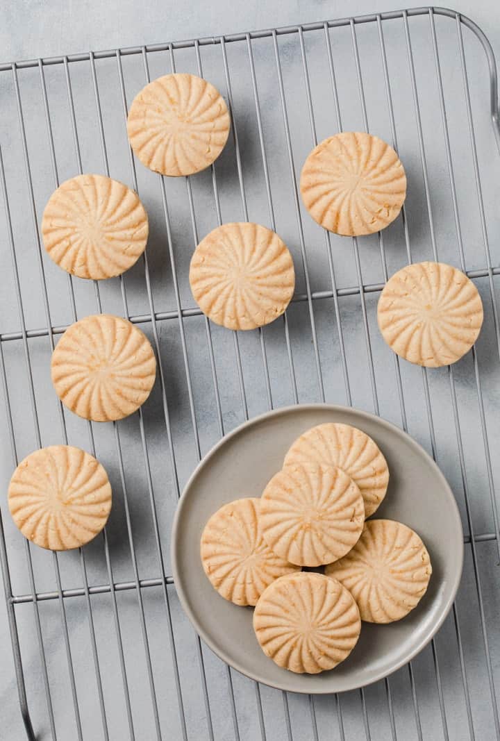 overhead of shortbread cookies on a grey plate and wire rack