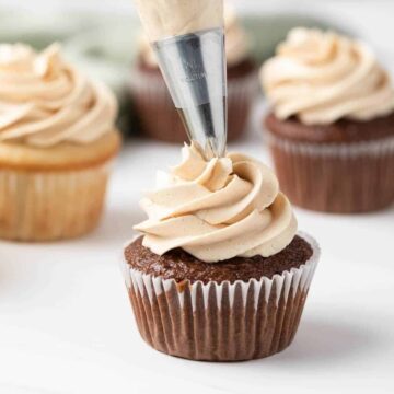 peanut butter frosting piped onto chocolate cupcake