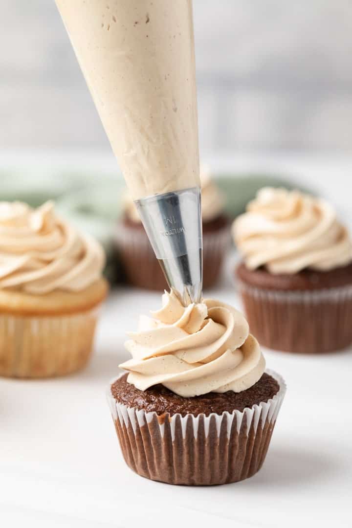 peanut butter frosting piped onto chocolate cupcake