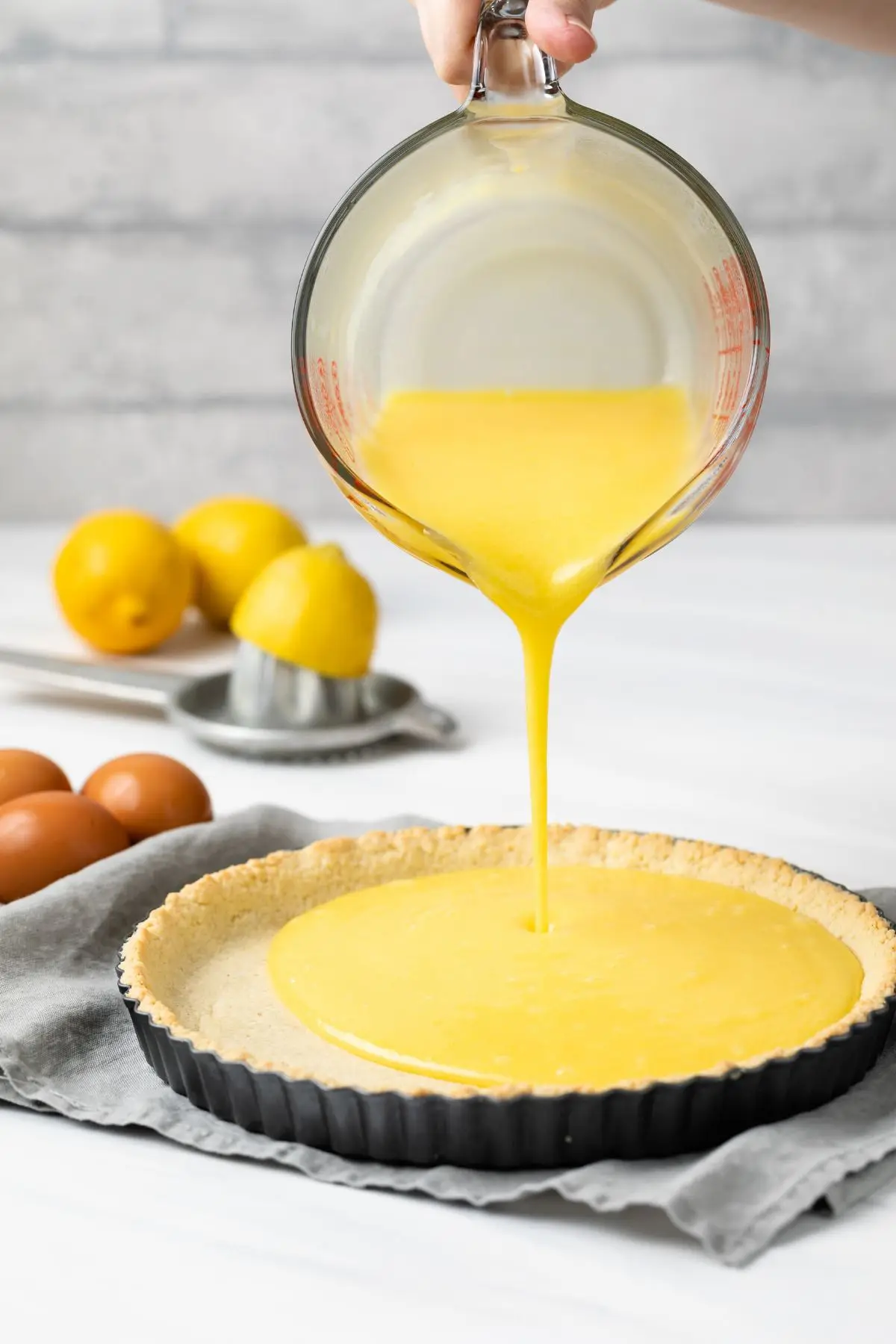 Lemon curd poured into gluten free tart crust.