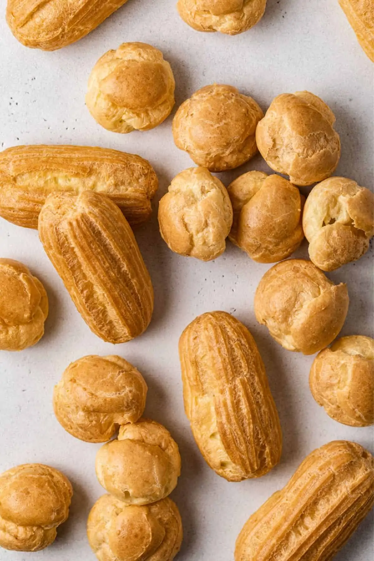 Overhead of baked eclair and cream puff shells.