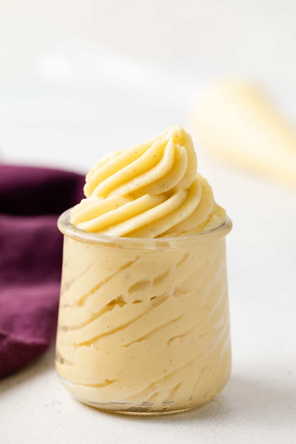Swirls of pastry cream piped in a glass jar.