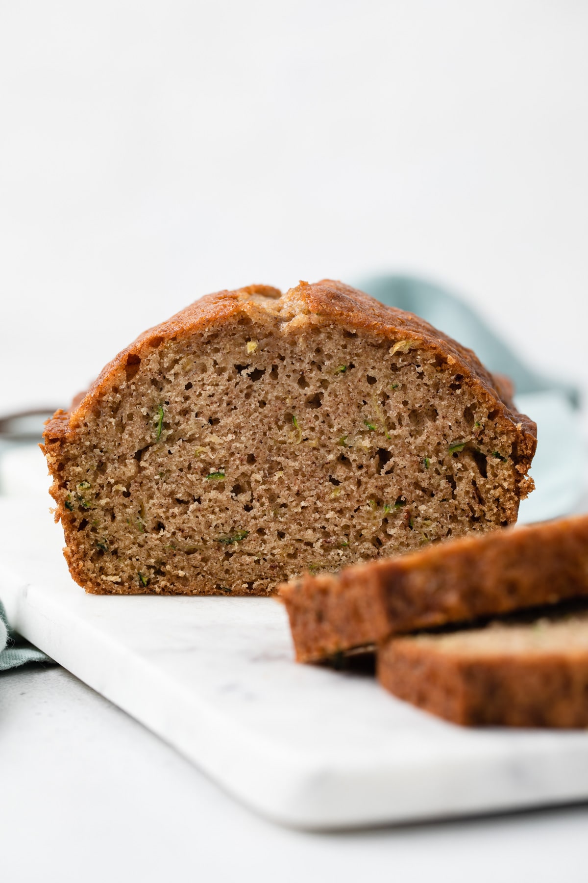 side view of zucchini bread with two slices take out