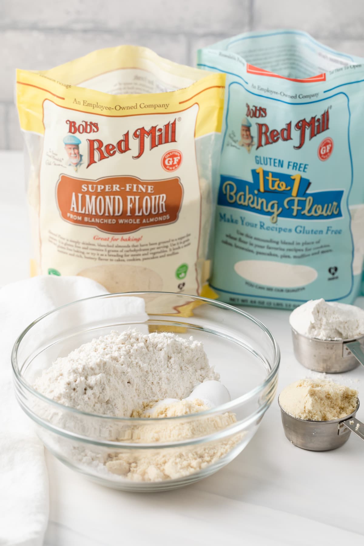 bowl of dry ingredients set in front of bag of Bob's Red Mill Almond Flour and bag of Bob's Red Mill Gluten-Free Flour