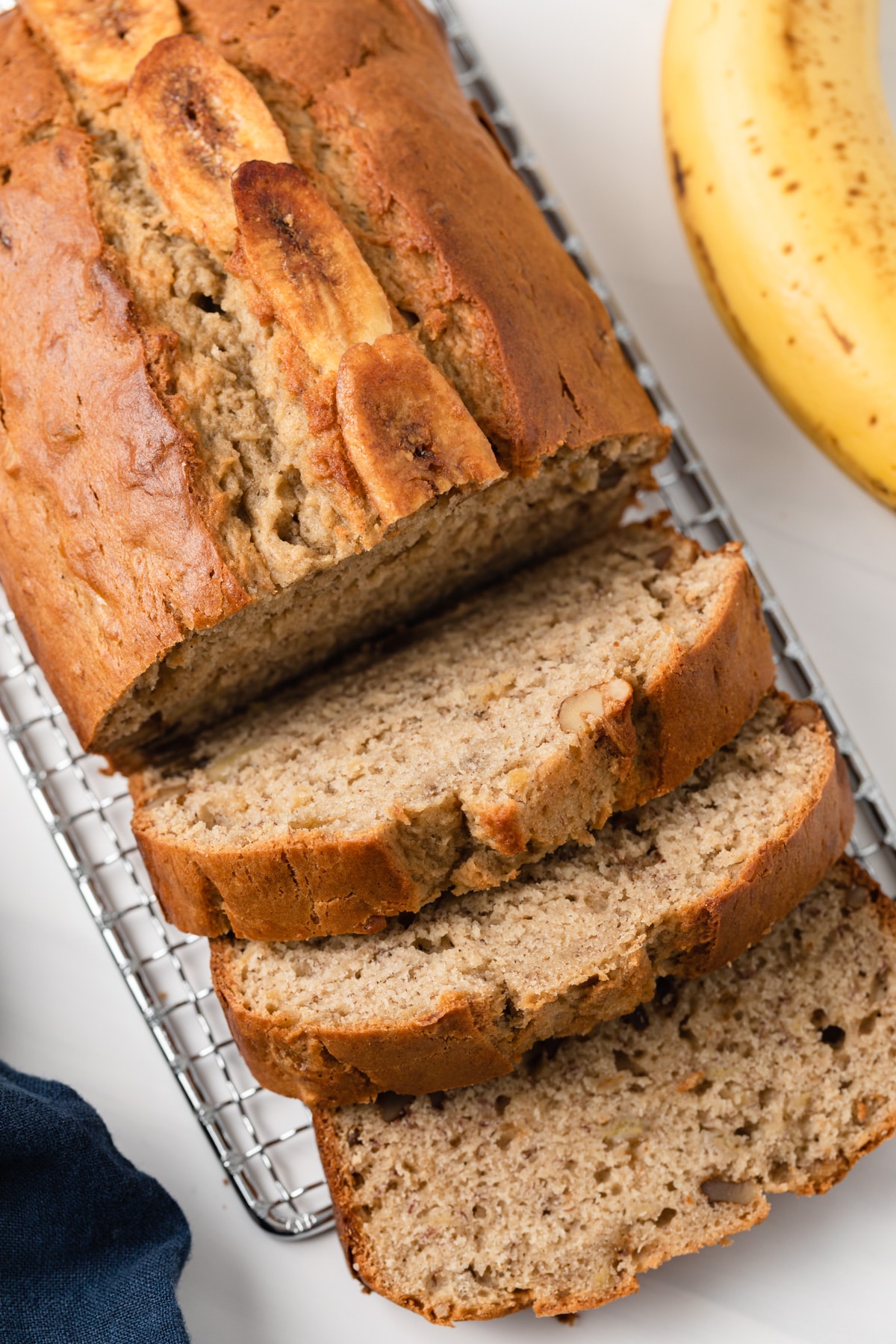 overhead of easy banana bread loaf with three slices cut out