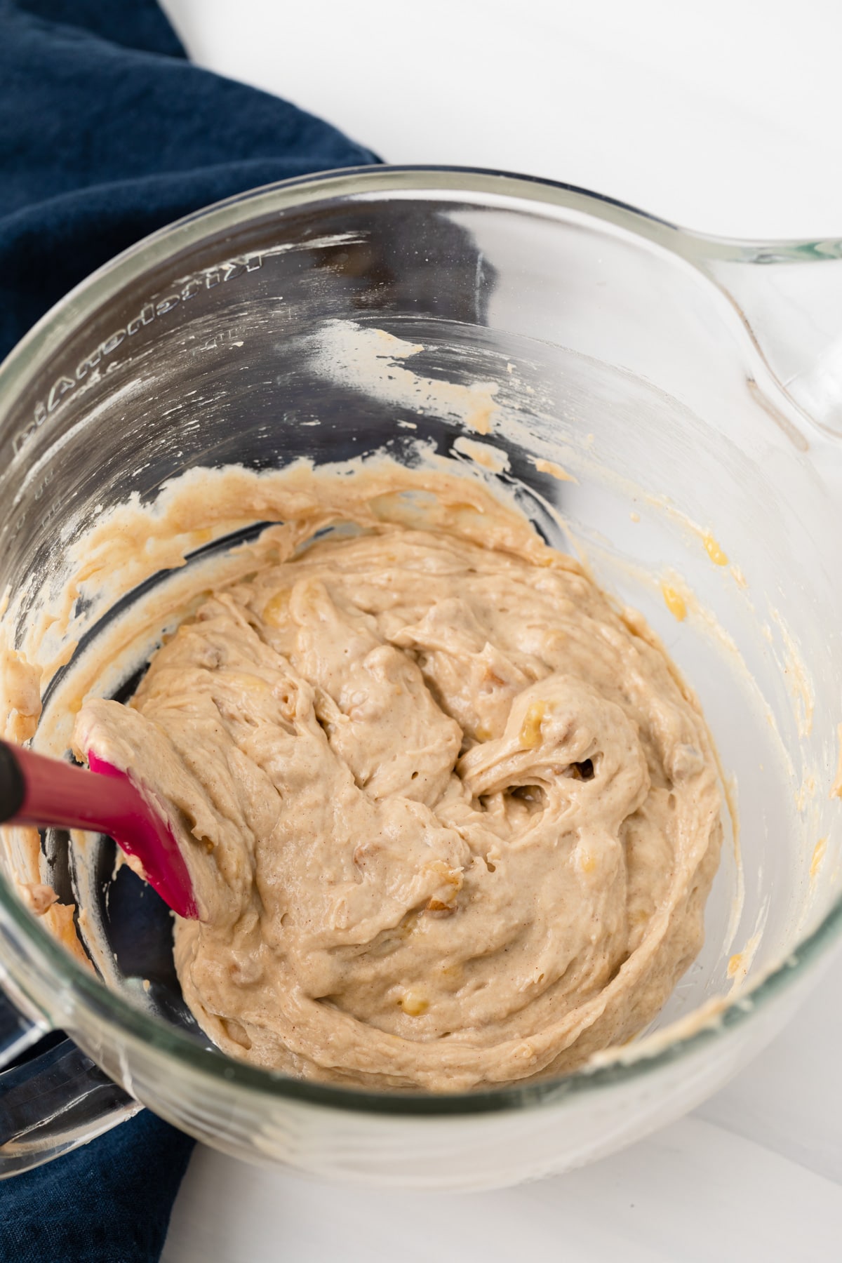 easy banana bread batter in glass bowl with pink spatula