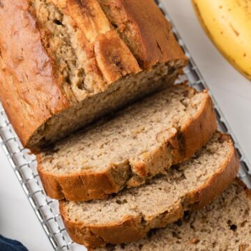 overhead of easy banana bread loaf with three slices cut out