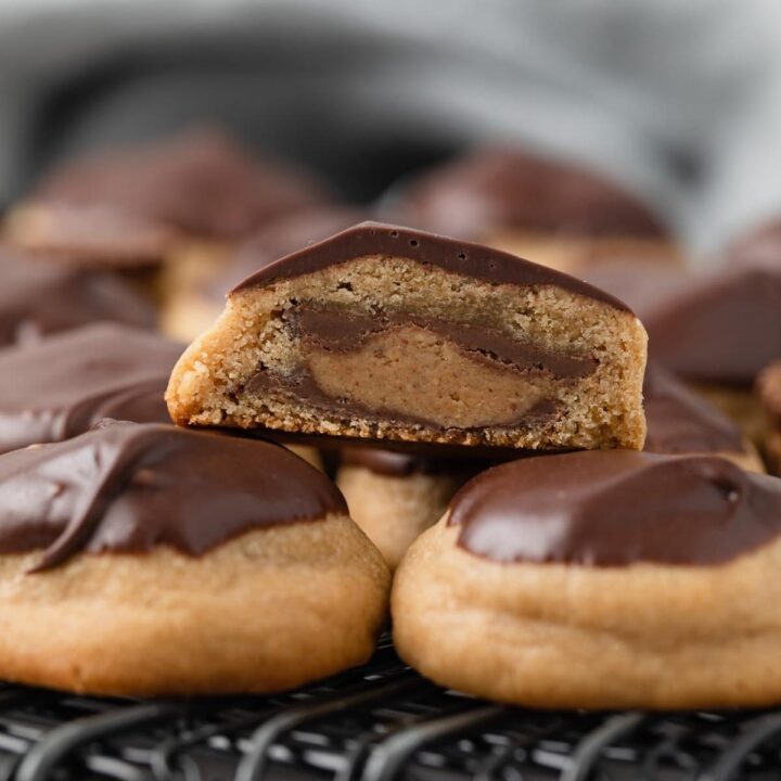 side view of peanut butter cup cookies with one slice open so the inside is visible