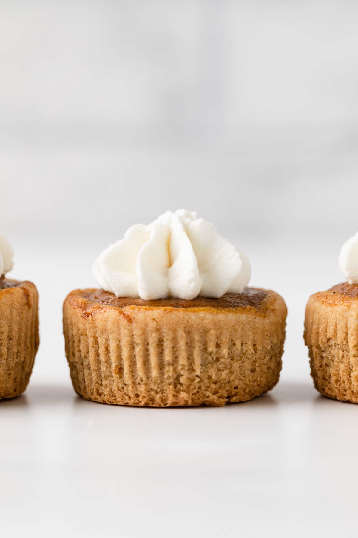 straight on view of mini pumpkin pie topped with whipped cream