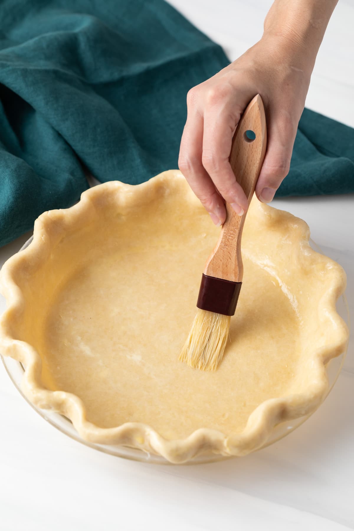 egg wash brushed over pie shell with pastry brush