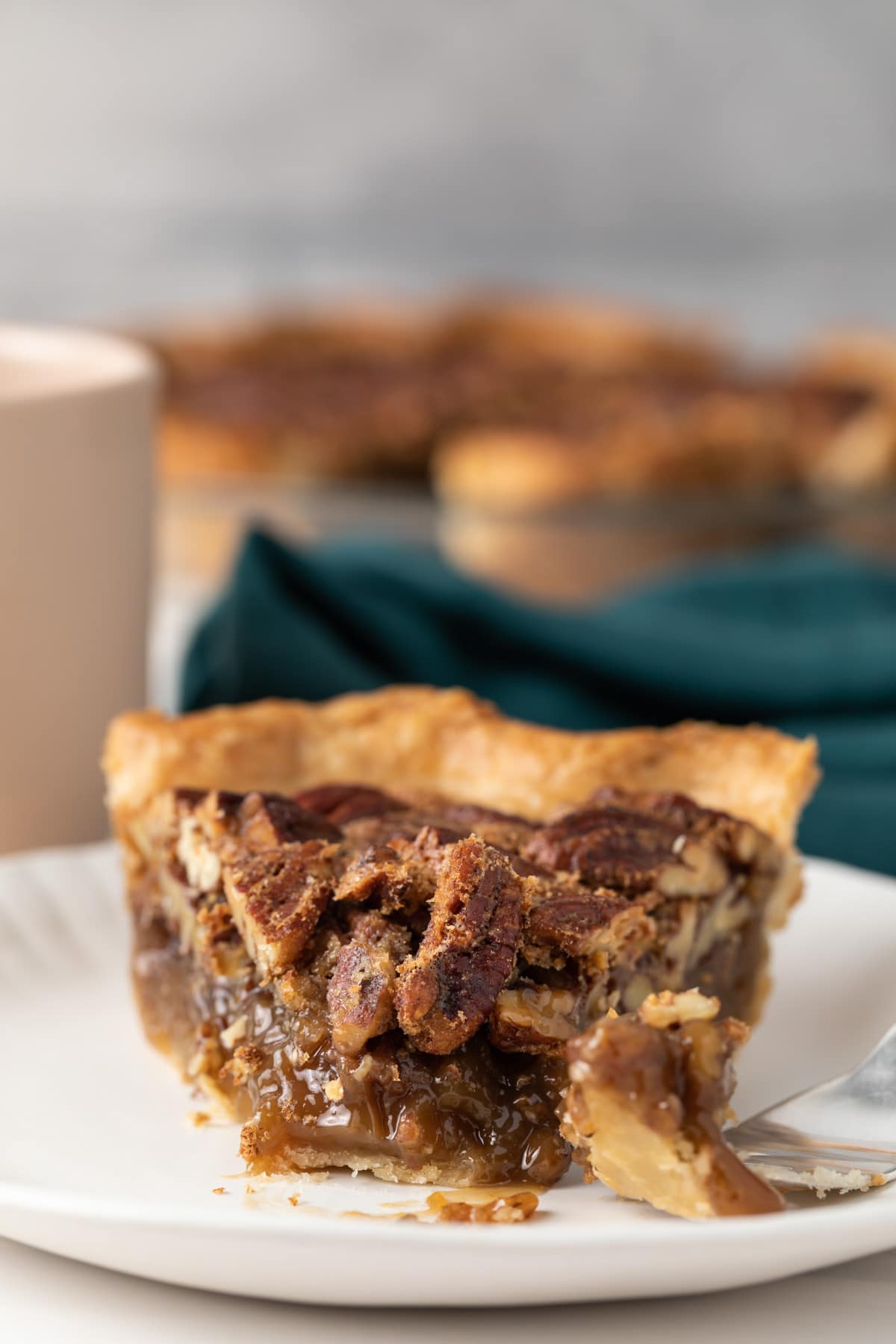 slice of pecan pie with fork taking a bite out