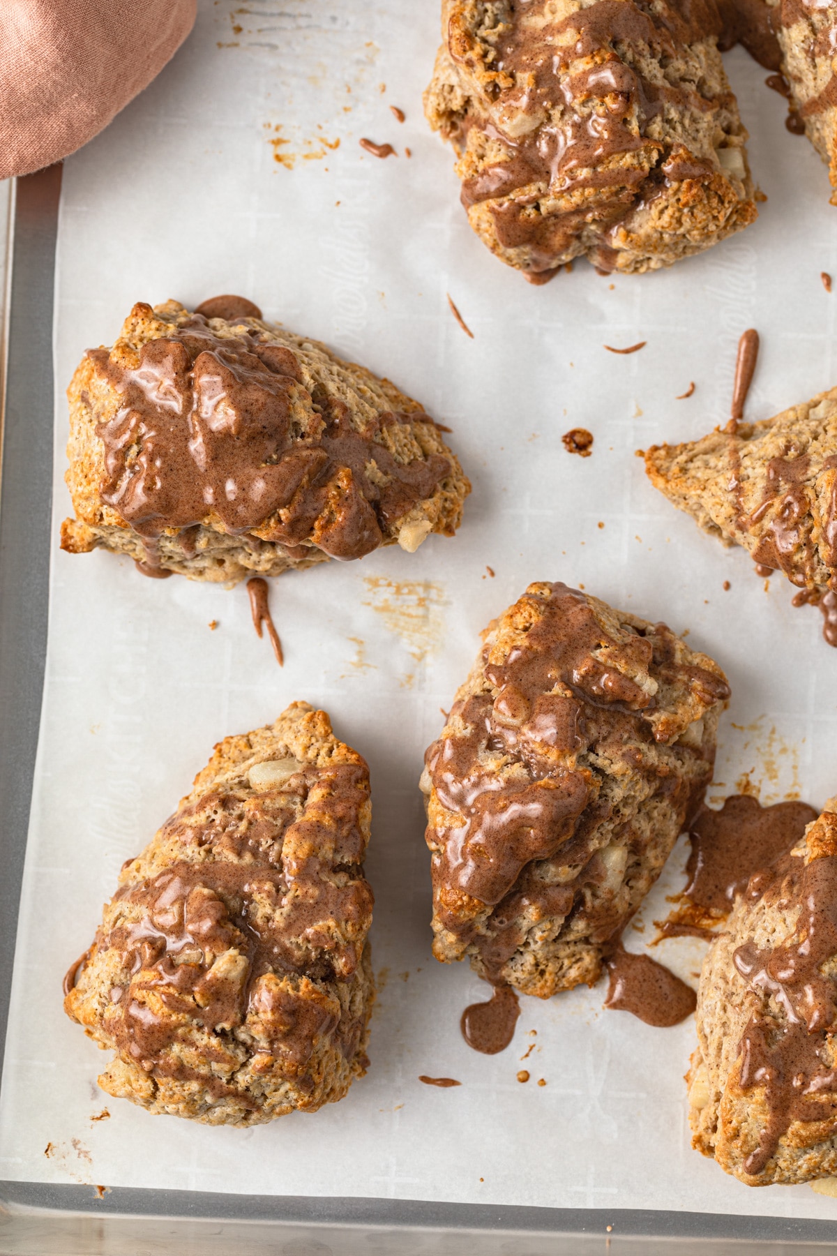 overhead of chai pear scones on baking sheet lined with white parchment paper