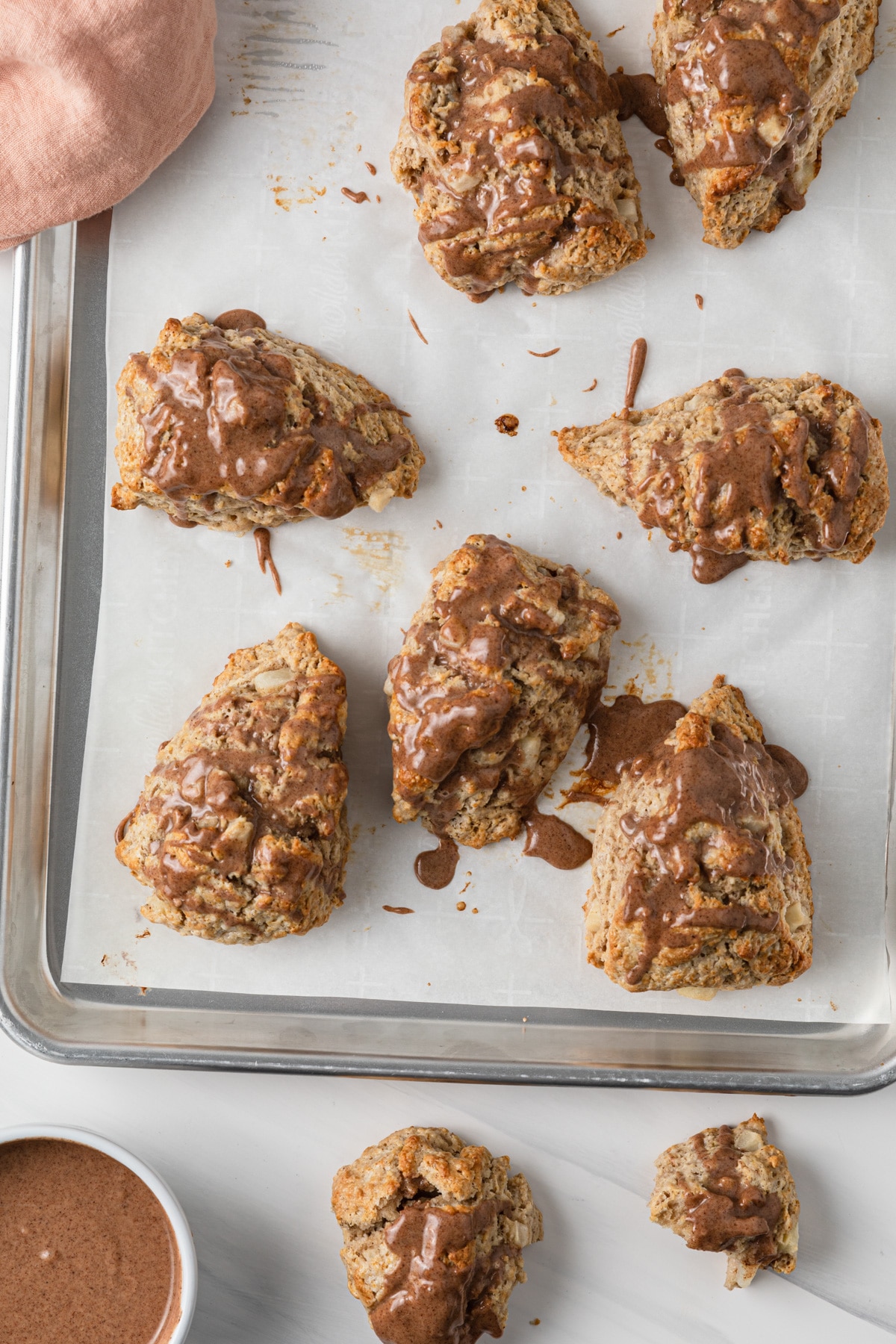 chai pear scones with cinnamon glaze on baking sheet