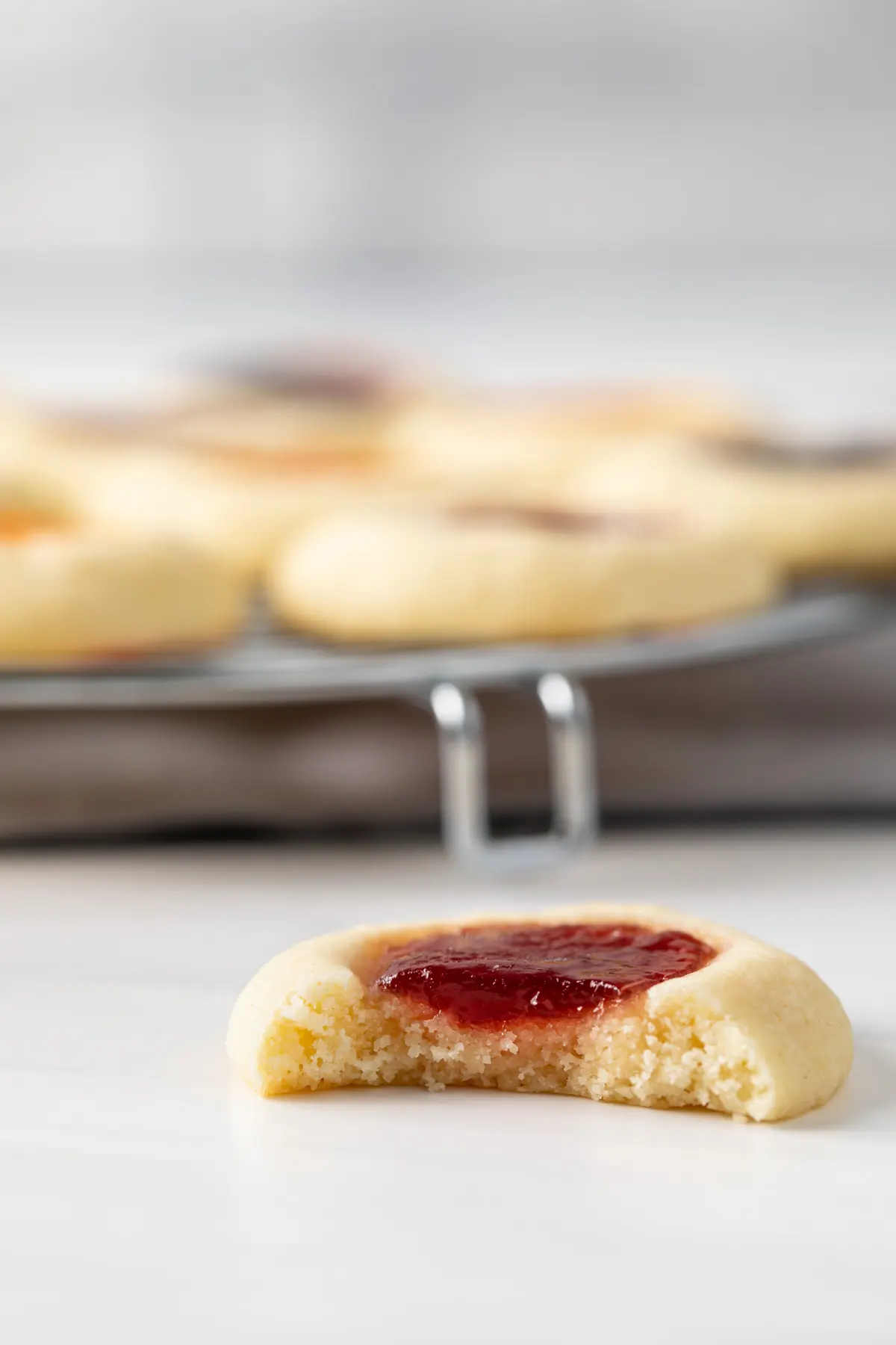 thumbprint cookie with a bite take out so the the inside texture is visible