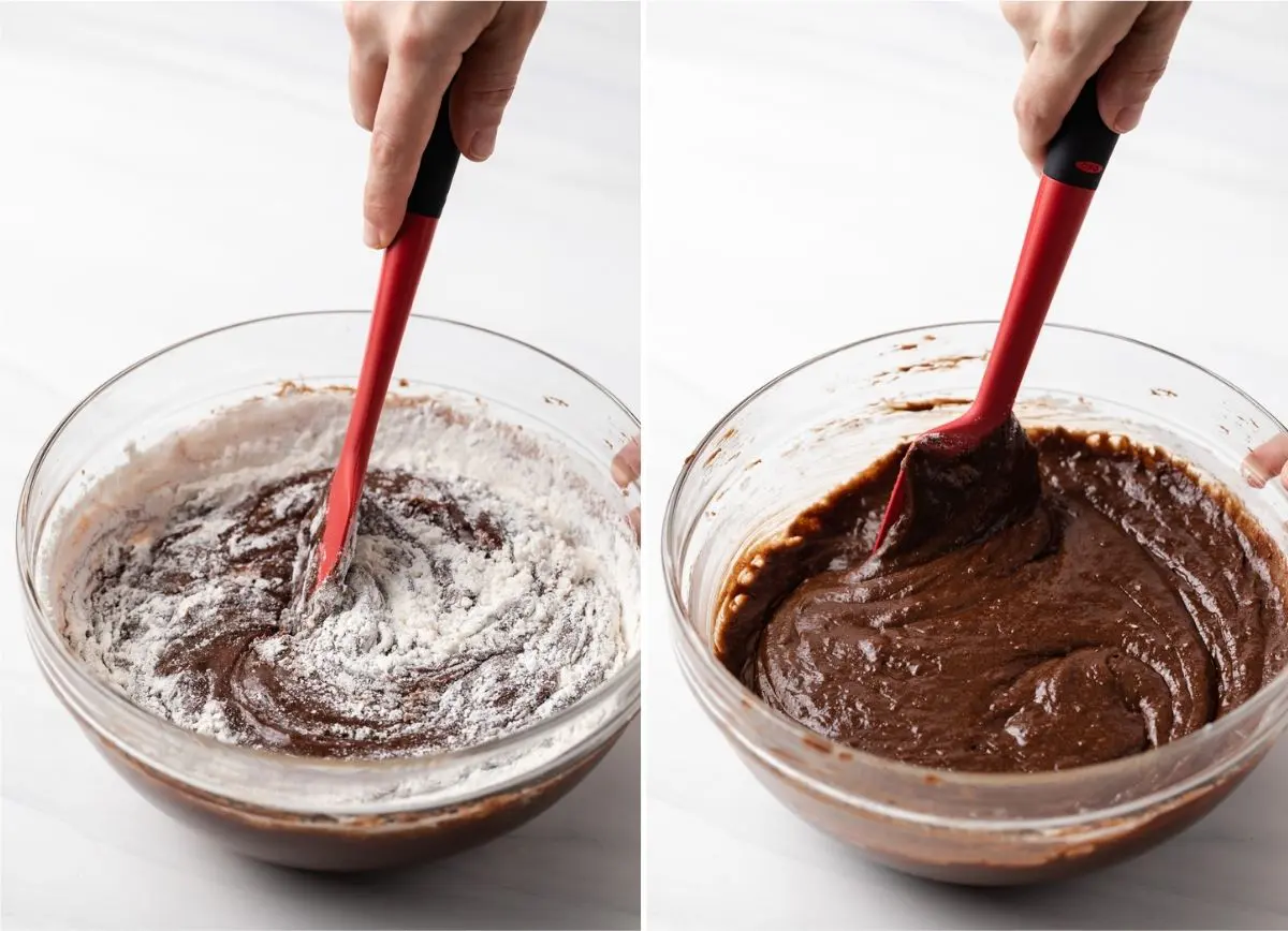 folding flour into chocolate mixture with red spatula and brownie batter in glass bowl