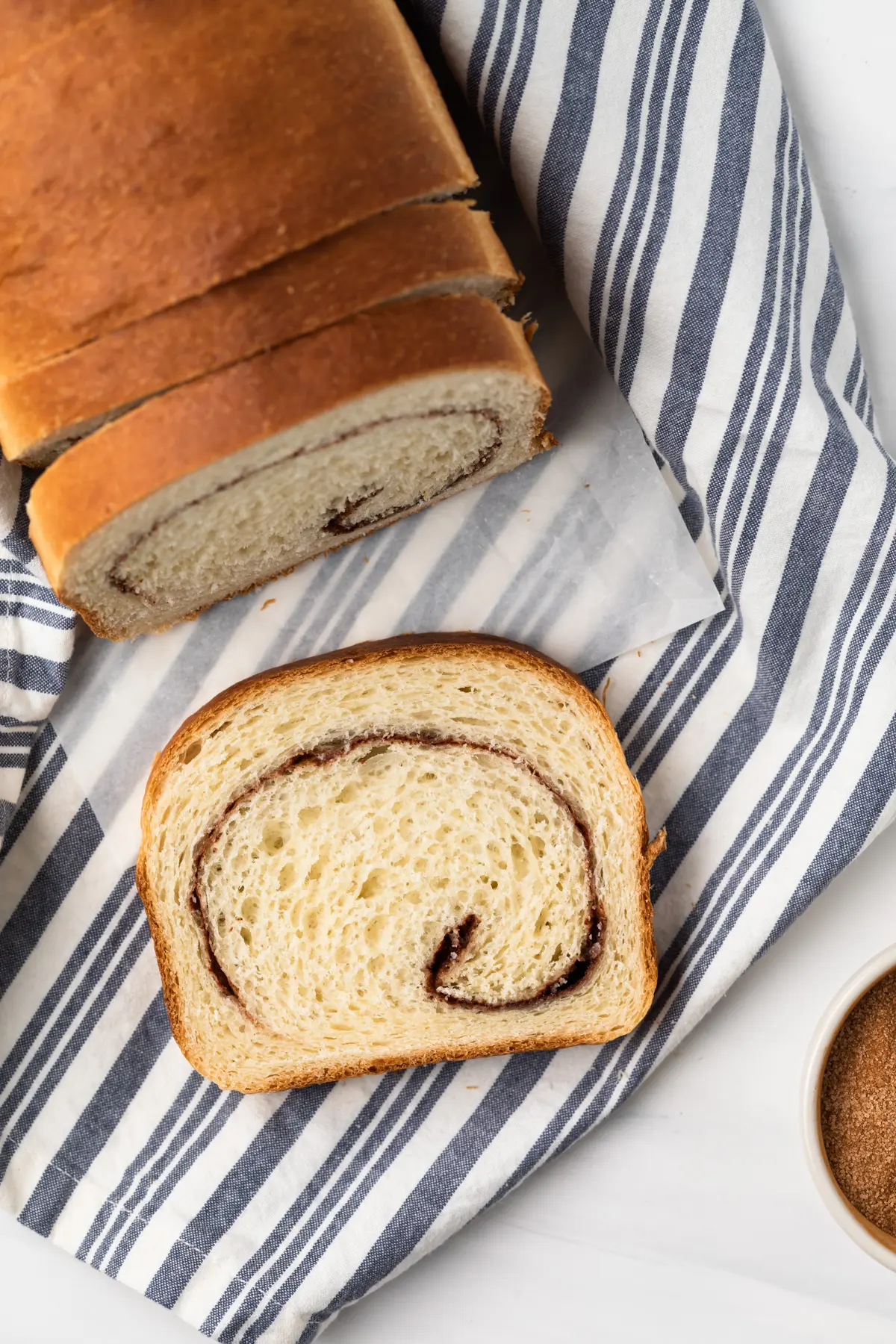 slice of cinnamon swirl bread next to loaf