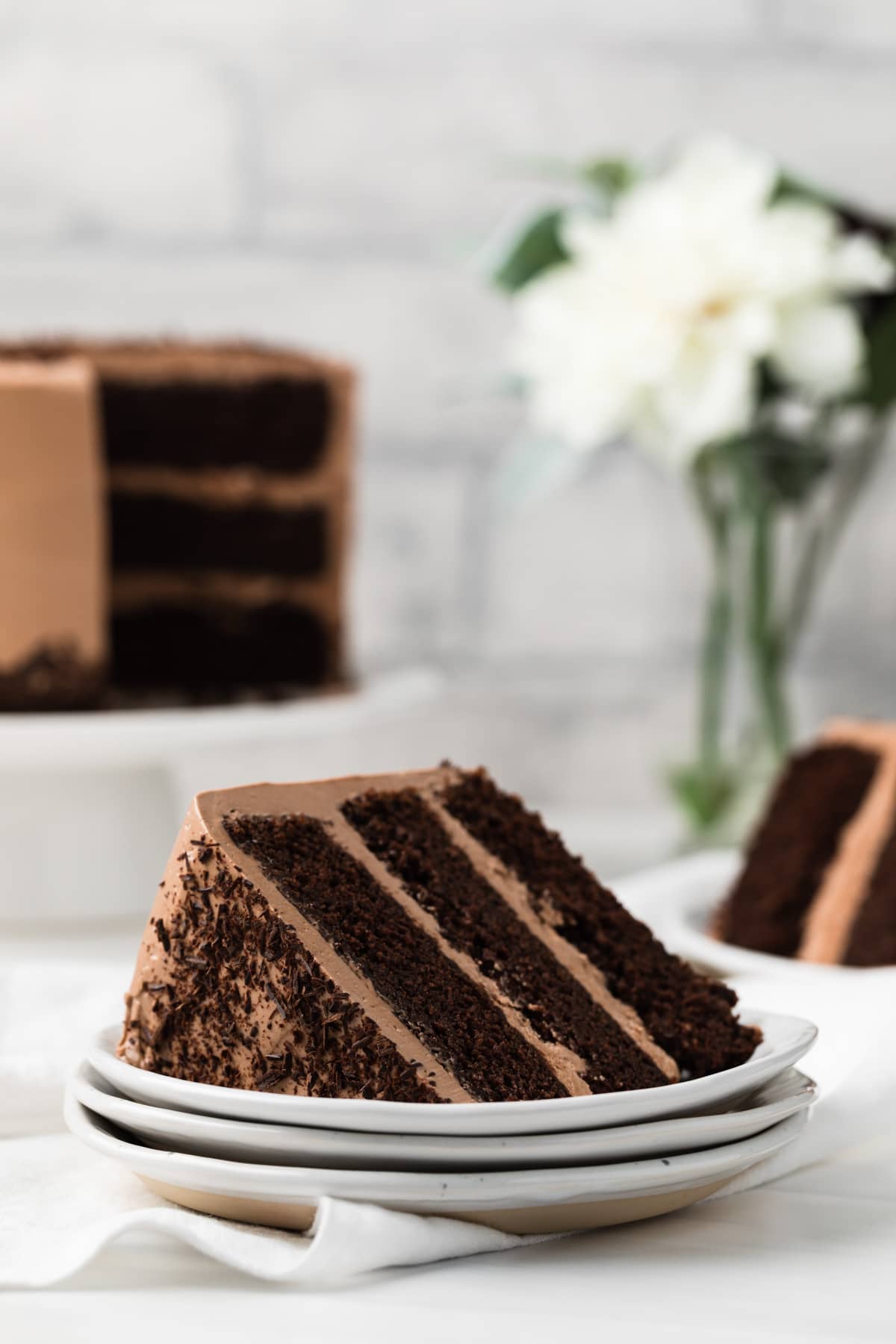 slice of Nutella cake on stack of three white plates