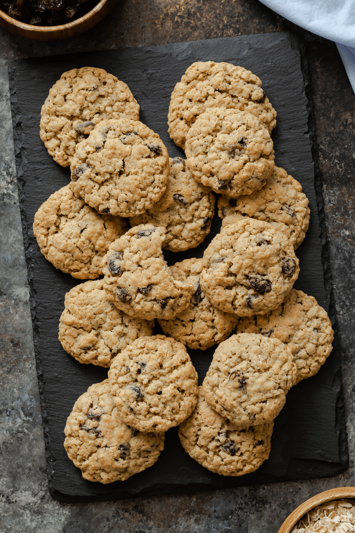 oatmeal raisin cookies scattered on a slate platter