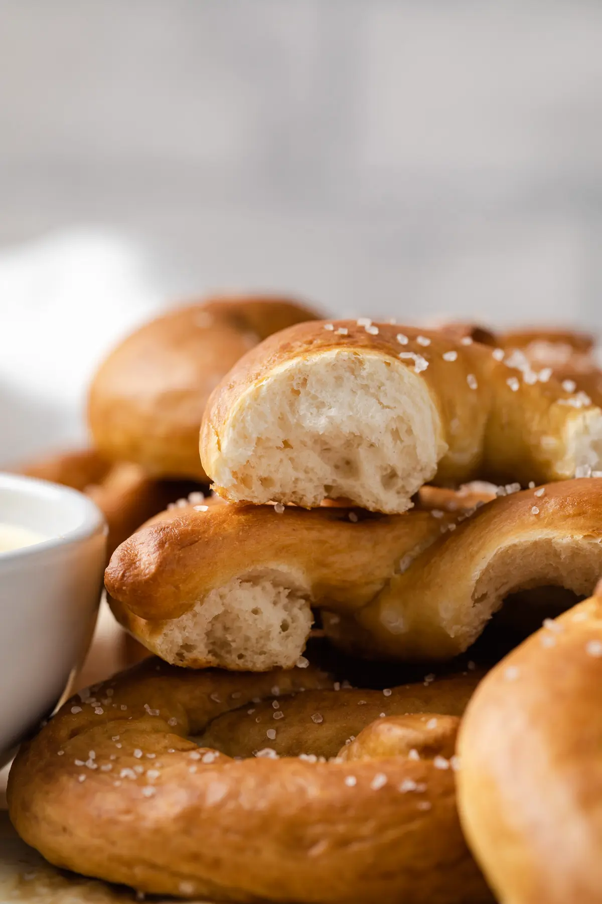 broken soft pretzel stacked on others with the interior visible