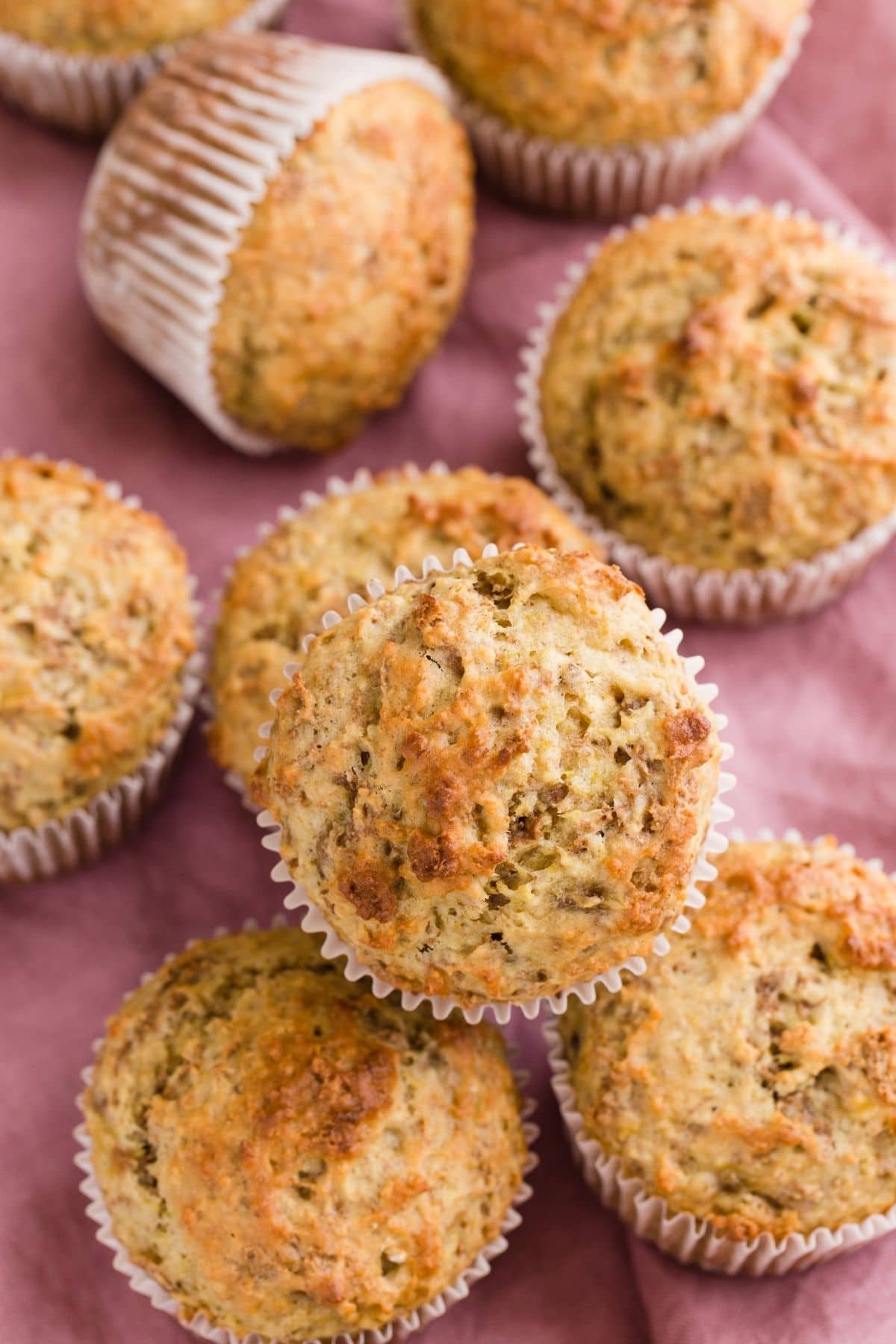 Close up view of Banana Bran Muffins on a pink napkin.