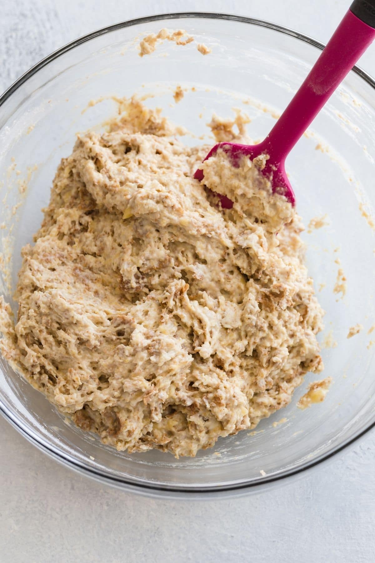 bowl of banana bran muffin batter with pink spatula