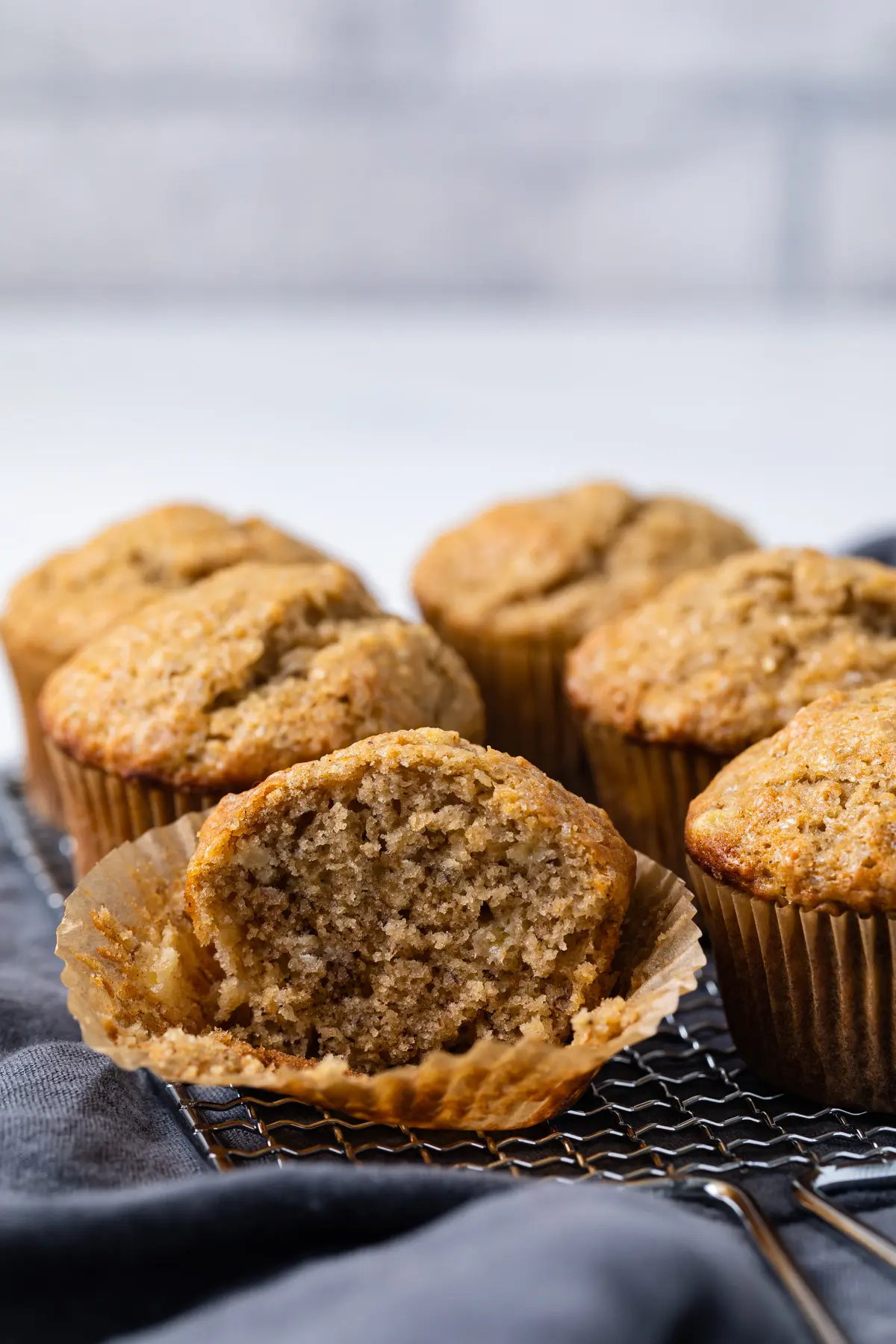 banana muffin with a bite taken out and still in paper liner