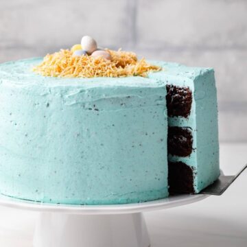 side view of chocolate Easter cake with slice being taken out