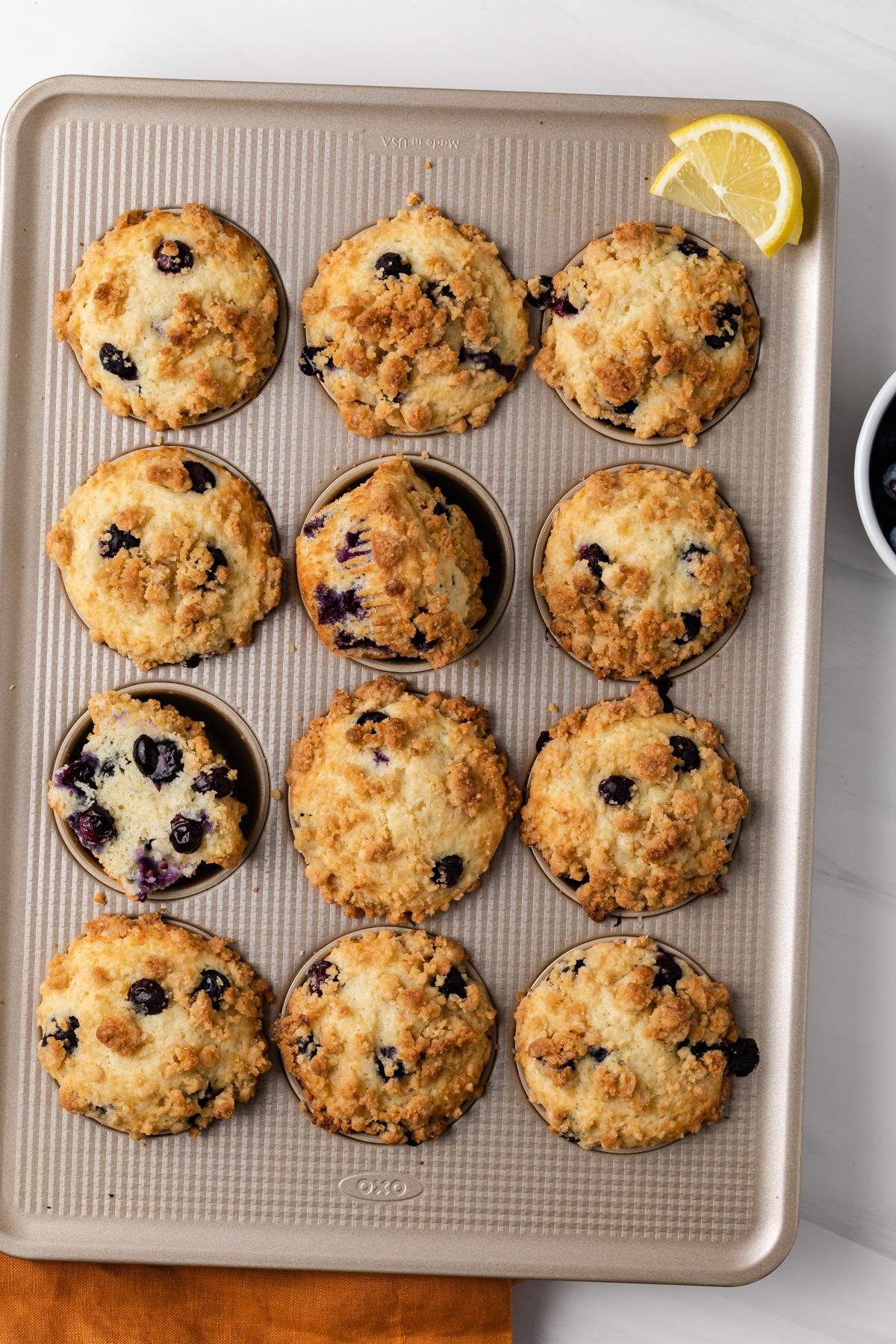 overhead of lemon blueberry muffins in a muffin pan