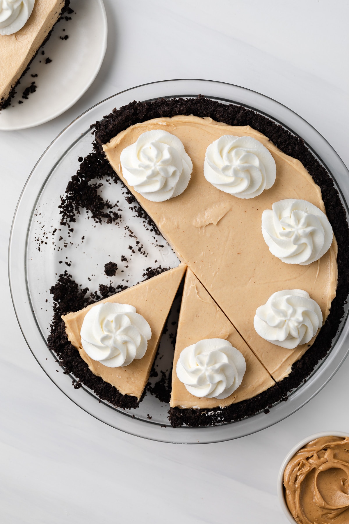 overhead of easy peanut butter pie in glass pan with slice taken out