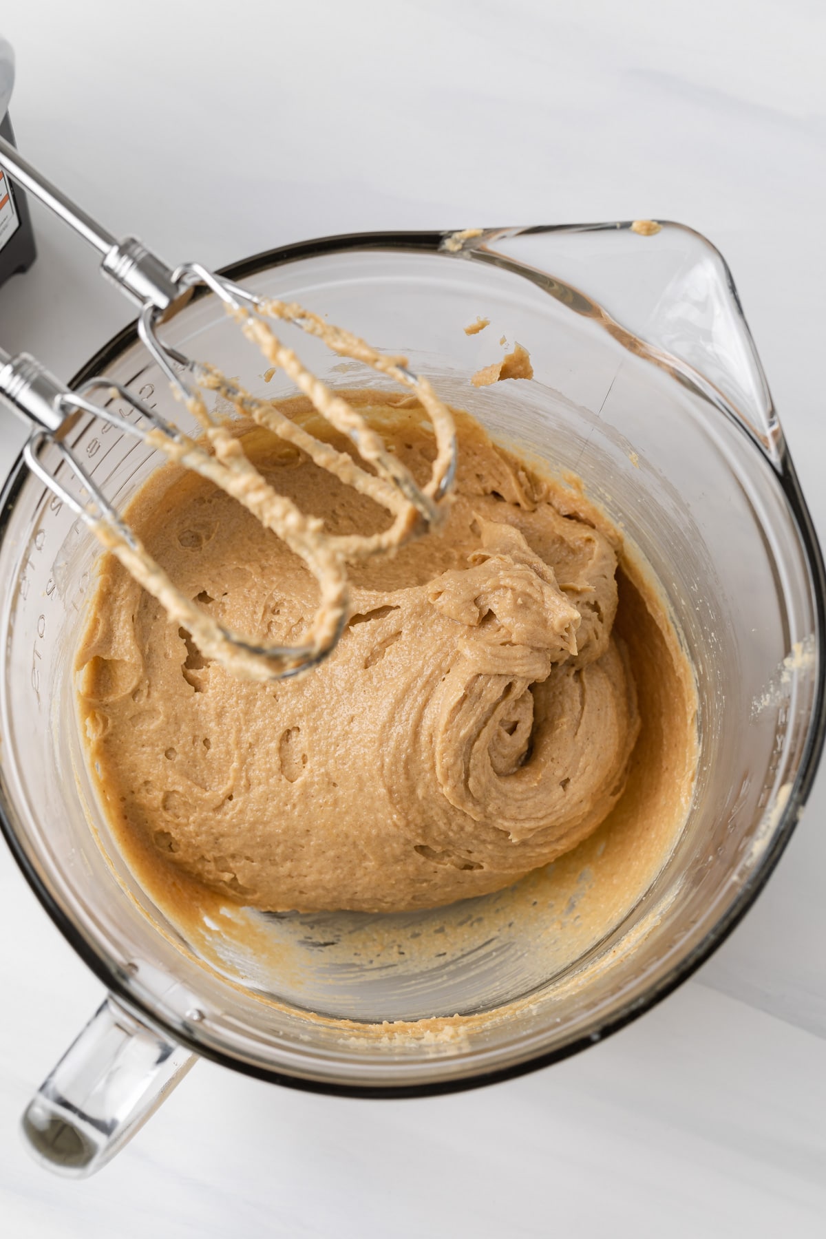 butter, shortening, sugar, eggs, and peanut butter creamed together in glass bowl