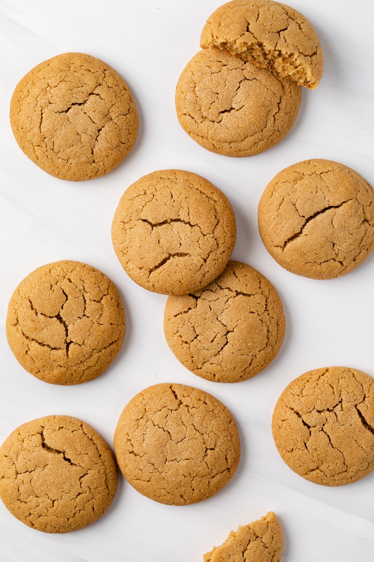 peanut butter cookies scattered on a white table top