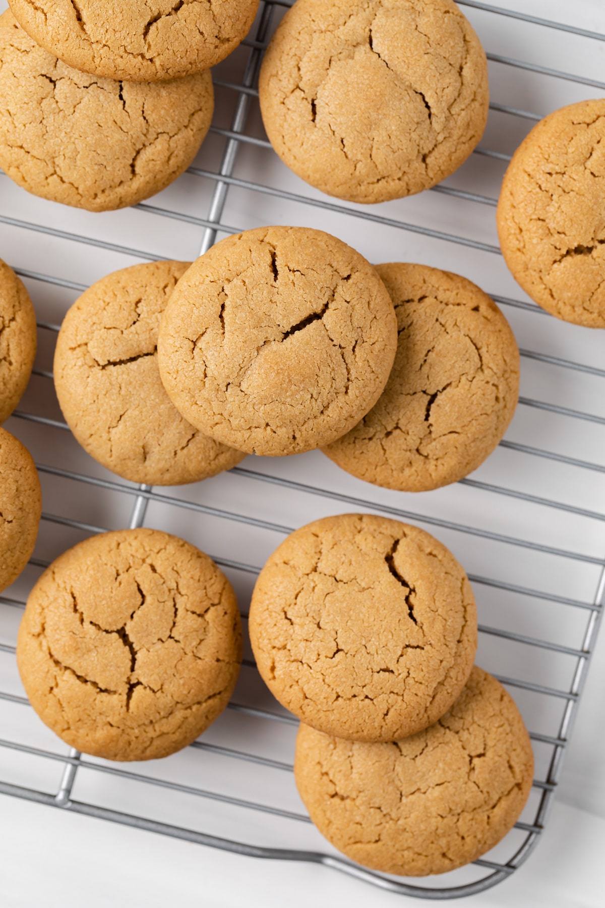 peanut butter cookies scattered on a wire rack