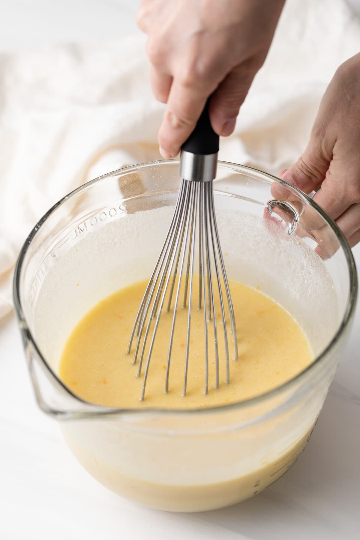 whisking chiffon cake batter in glass bowl