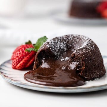 side view of chocolate lava cake with the molten middle spilling out
