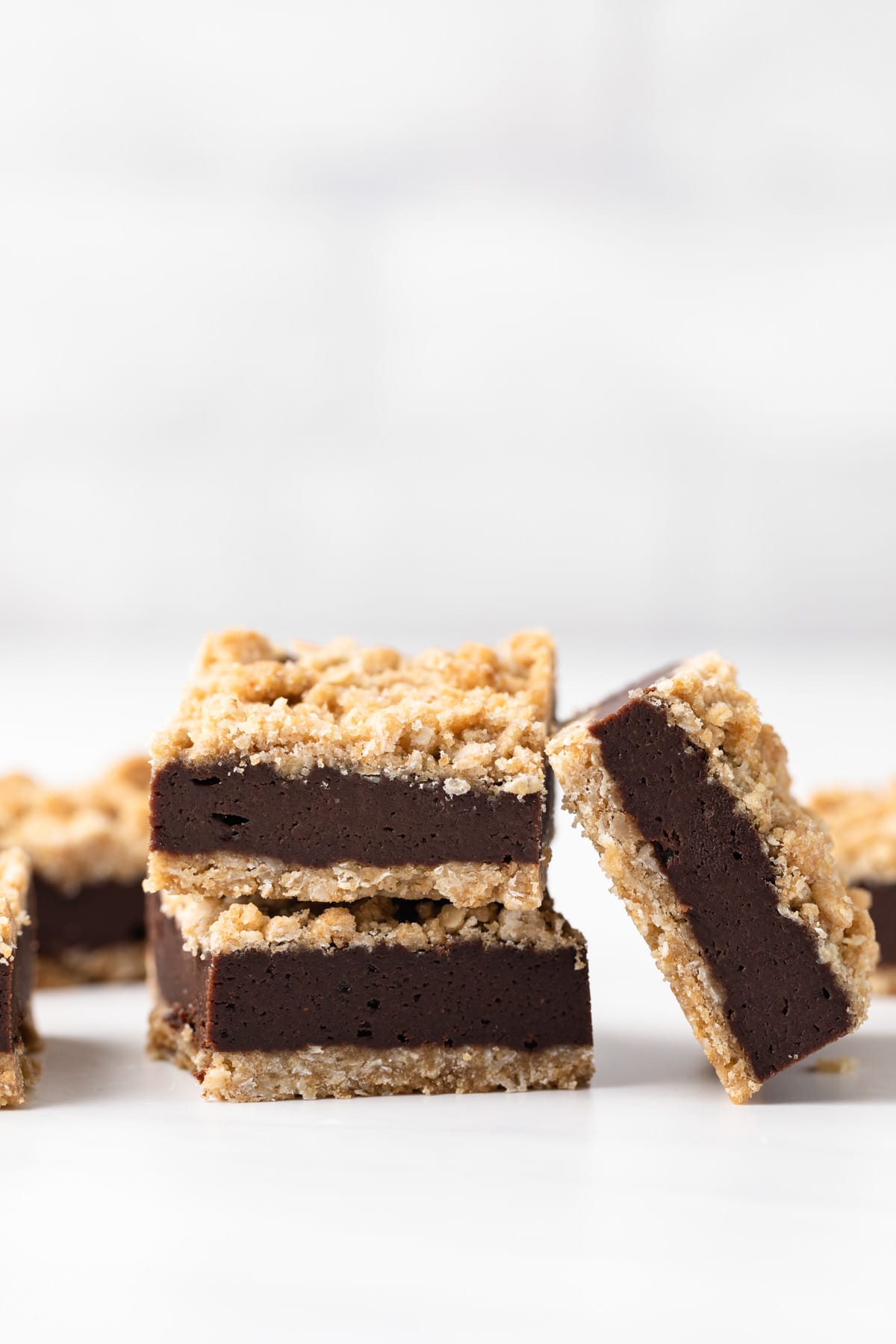 two chocolate oat bars stacked and one leaning on the two