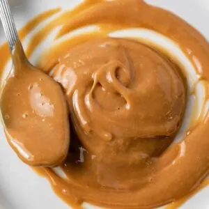 dulce de leche spread on white plate with spoon