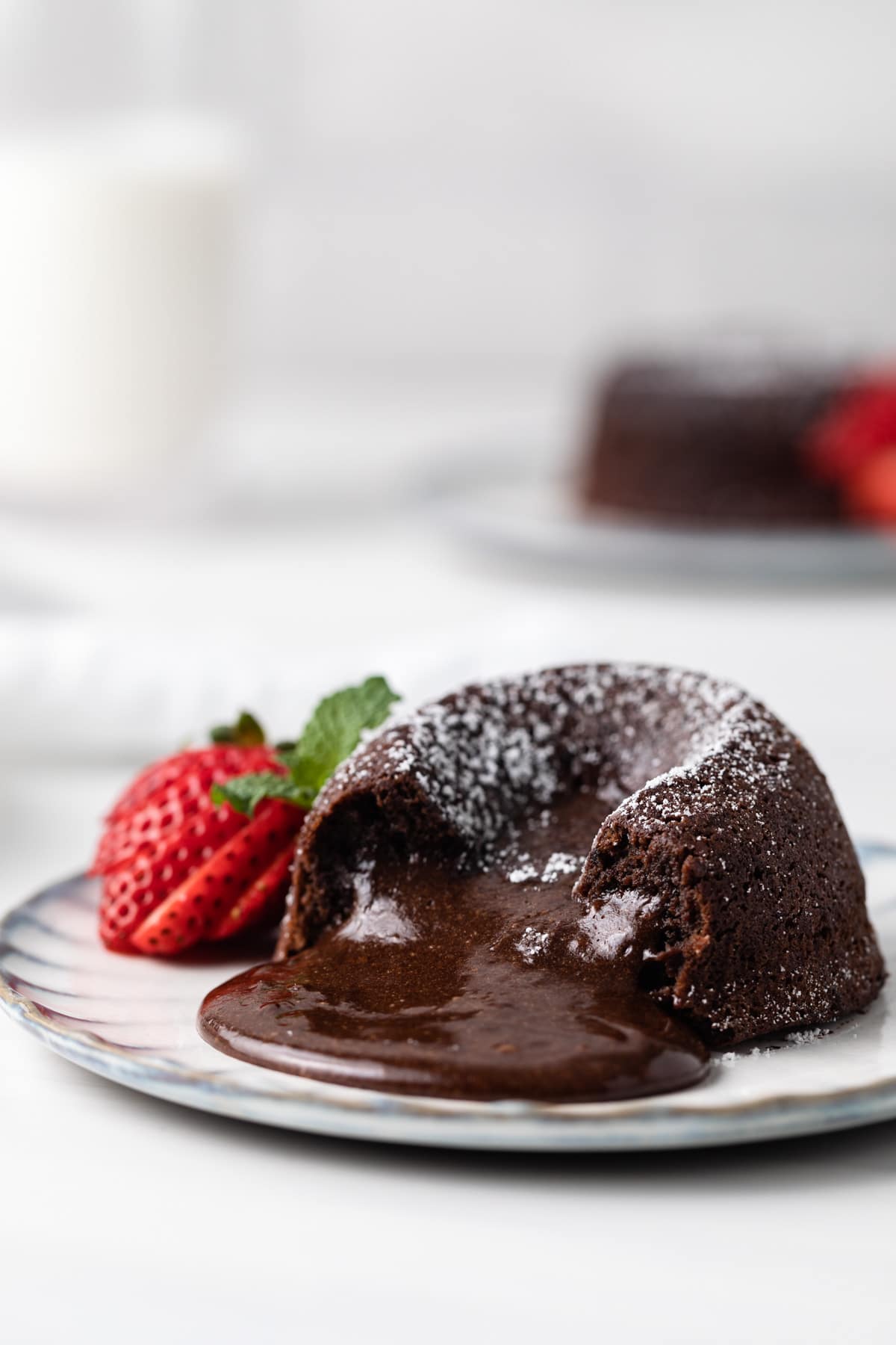 side view of chocolate lava cake with the molten middle spilling out