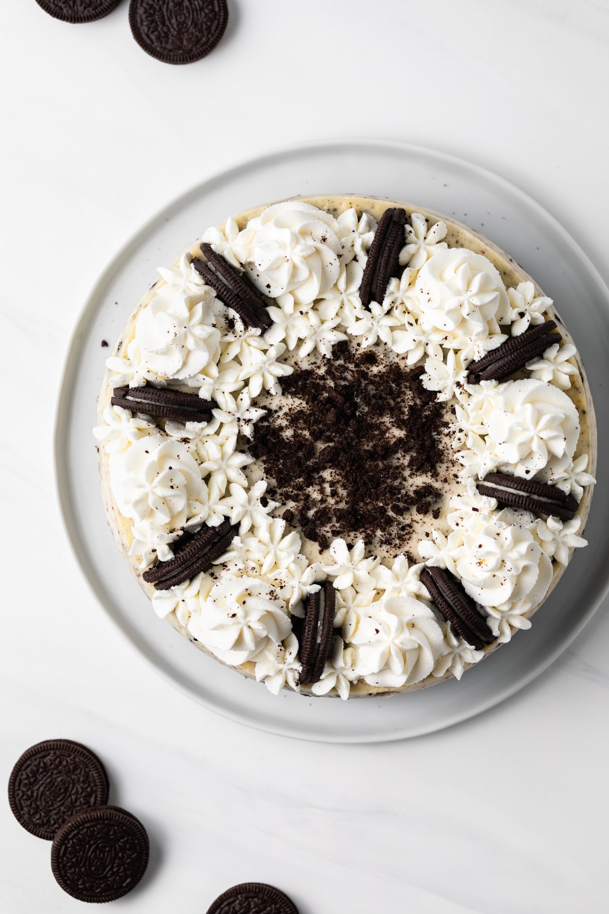 overhead of oreo cheesecake topped with whipped cream and oreos
