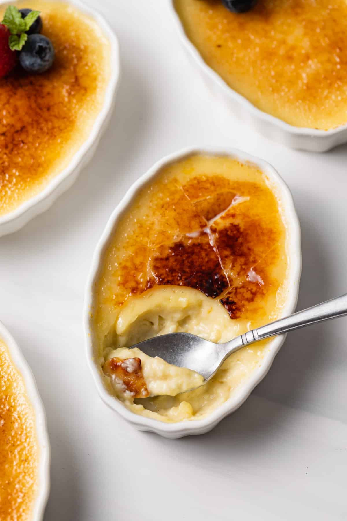 spoon taking out a bite of creme brulee