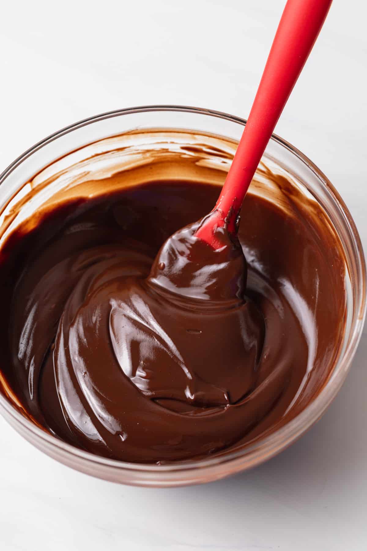 bowl of melted chocolate with red spatula