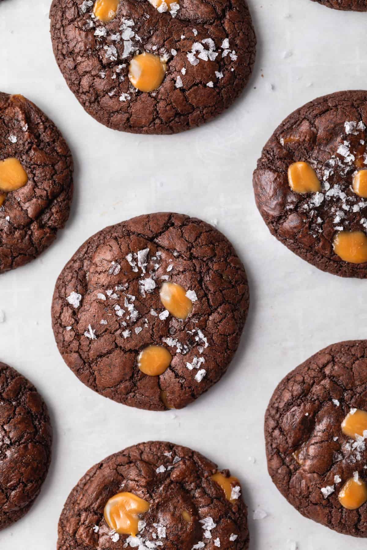 overhead of brownie cookies dotted with salted caramel and flaked salt