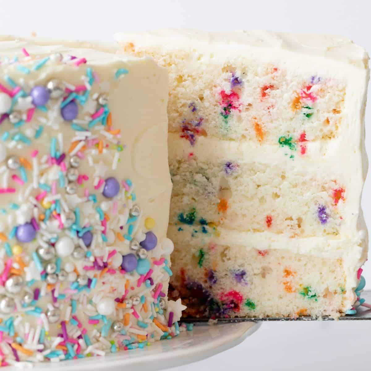 Funfetti cake with slice being taken out.