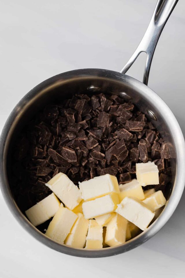 Chopped chocolate and butter cubes in a pot.