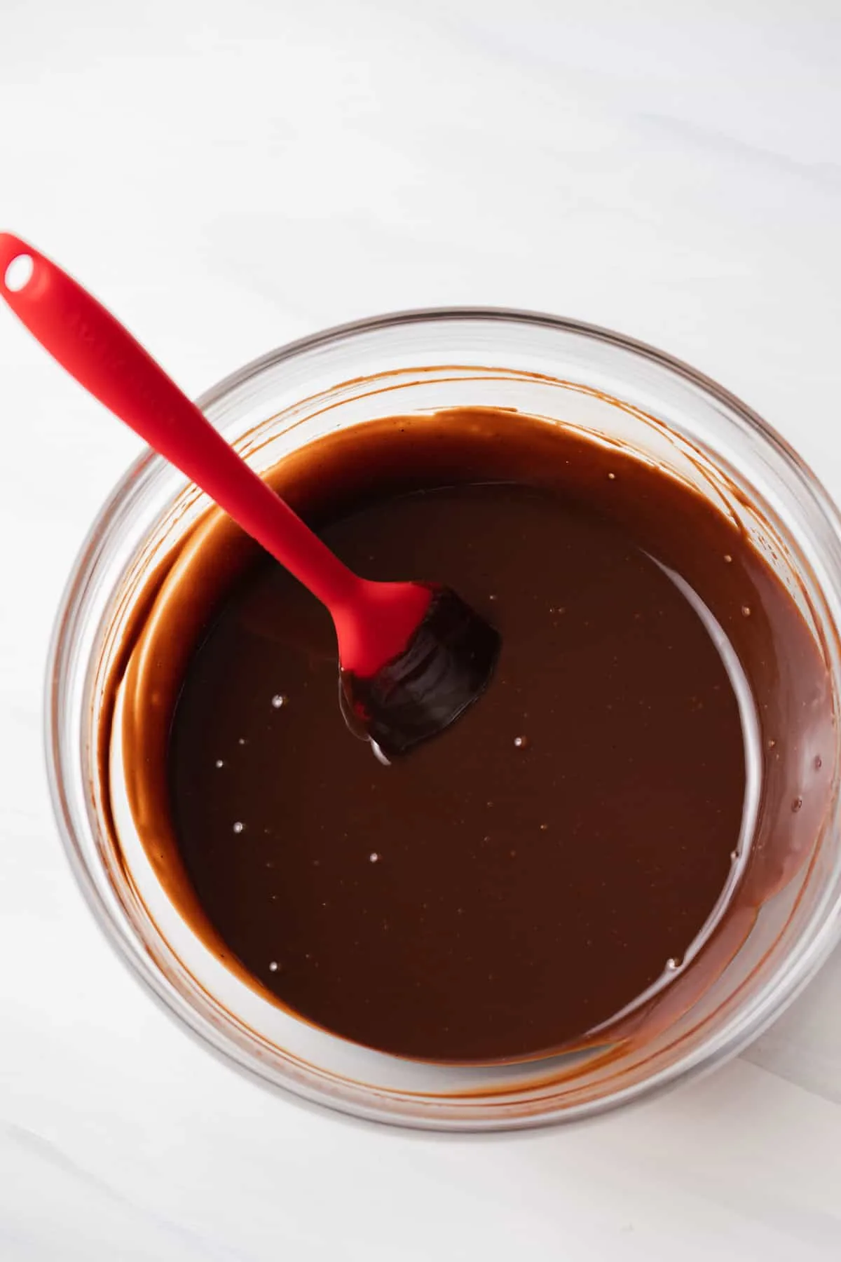 Melted chocolate in glass bowl.