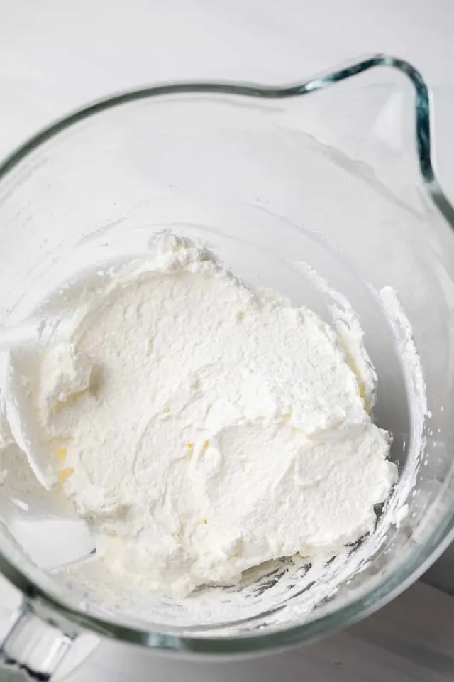 Whipped cream in glass bowl.