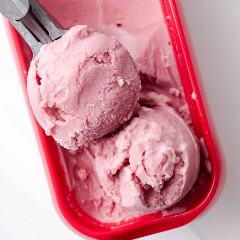 Overhead of water melon sorbet in ice cream container.