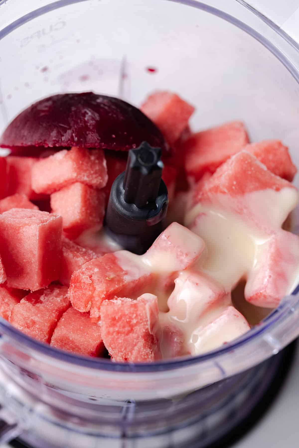 Frozen watermelon cubes, from pomegranate cubes, and condensed milk in food processor.