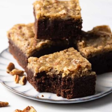 Four pecan pie brownies on a plate