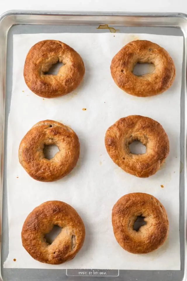 Maple Cinnamon Bagels on parchment lined baking sheet